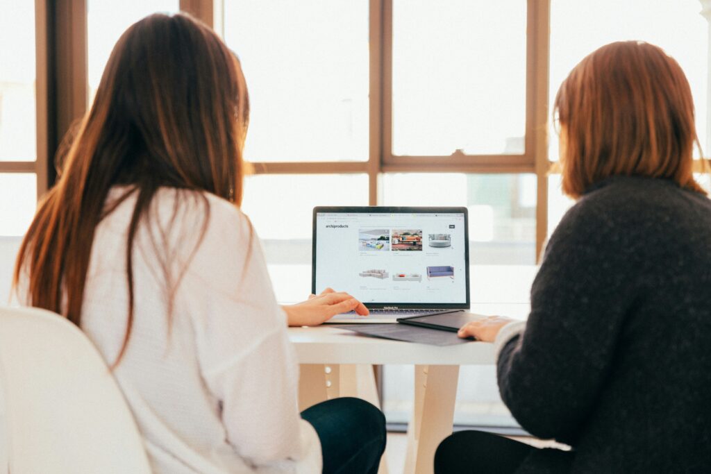 Two women looking at a computer screen